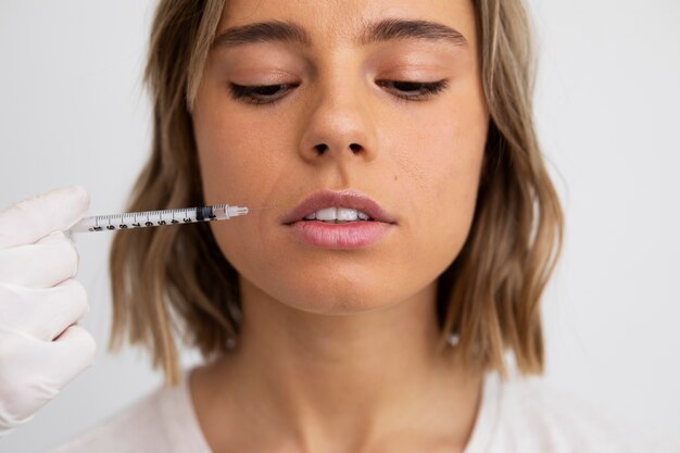 Close up woman getting lip filler