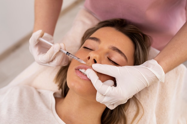 Close up woman getting lip filler