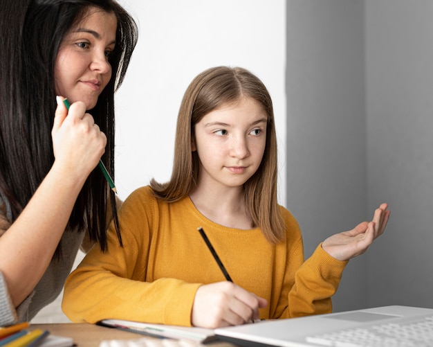 Close up woman and girl learning