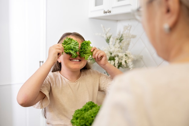 Close up woman and girl with lettuce