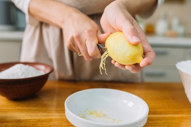 Close-up of a woman grating lemon