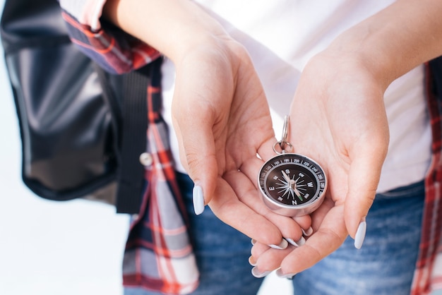 close-up of woman hand holding navigational compass
