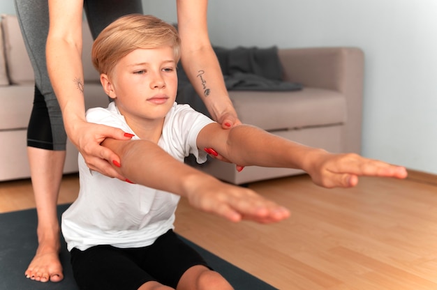 Close up woman helping child indoors