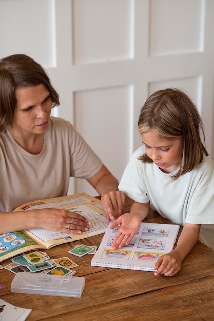 Close up woman helping girl study