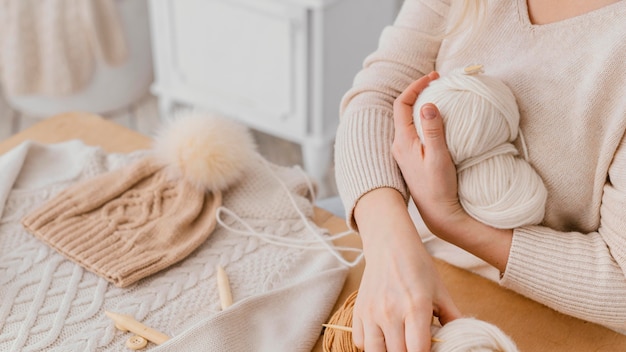 Close-up woman holding balls of thread