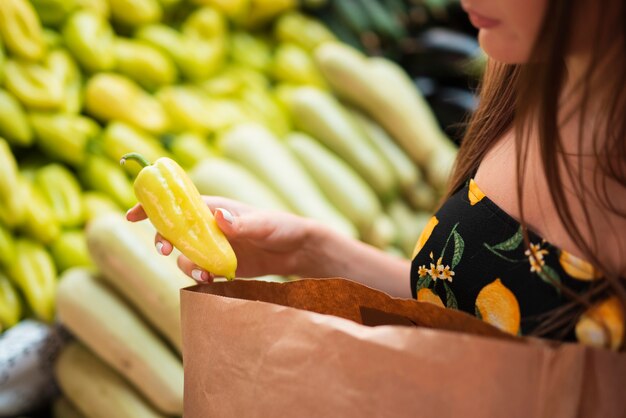 Close-up woman holding a bell pepper