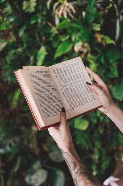 Close-up of a woman holding book in hand