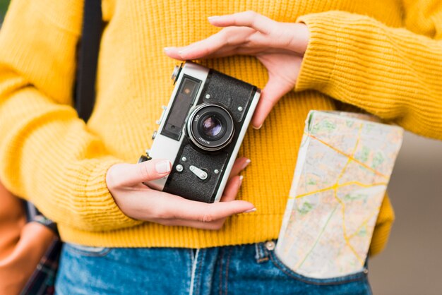 Close-up of woman holding camera