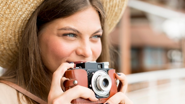 Close-up woman holding camera