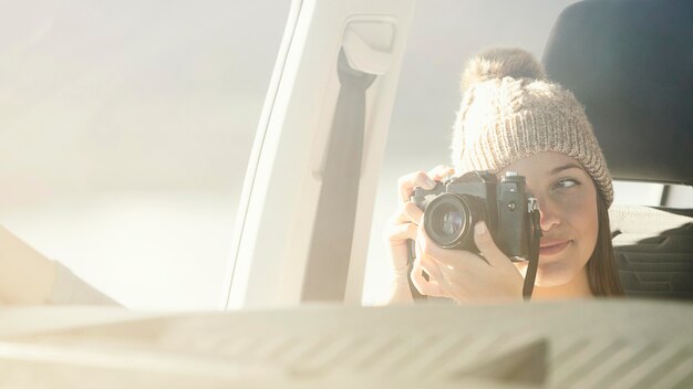 Close-up woman holding camera