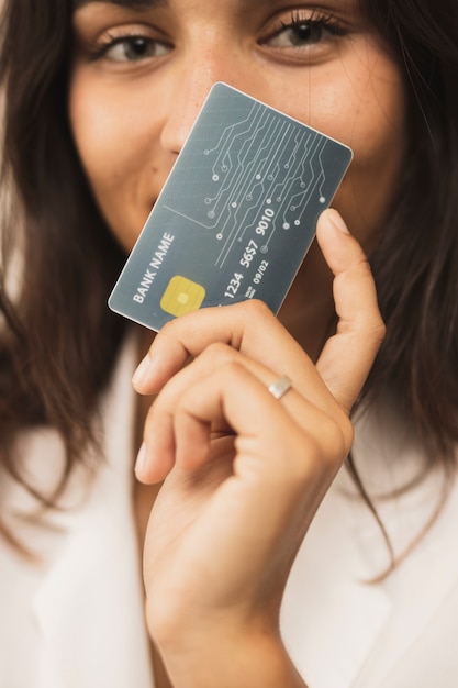 Close-up woman holding a card and looking at camera