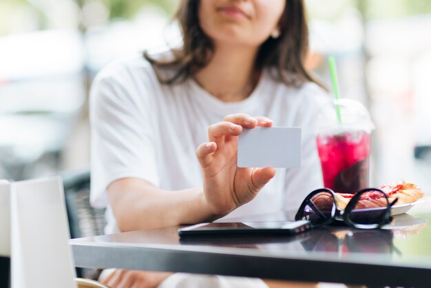 Close-up woman holding a card