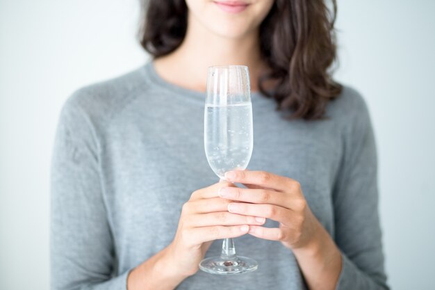 Close-up of woman holding champagne flute