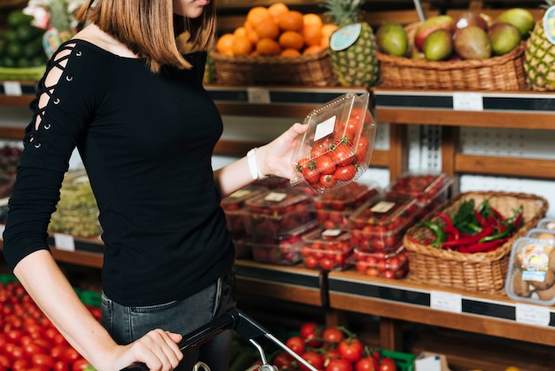 Close-up woman holding cherry tomatoes