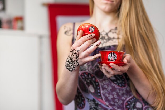 Close-up of a woman holding chinese tea in a traditional tea ceremony