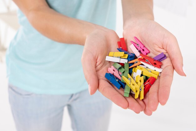 Close-up woman holding clothes-pins