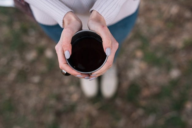 Close-up woman holding coffee