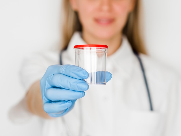 Close-up woman holding container