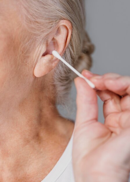 Close-up woman holding cotton swab