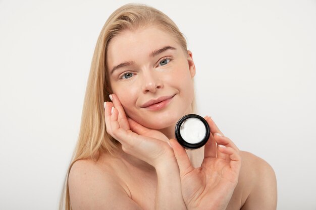 Close up woman holding cream container