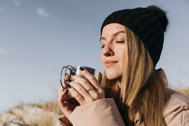 Close-up woman holding cup