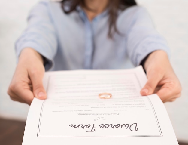 close-up woman holding divorce form