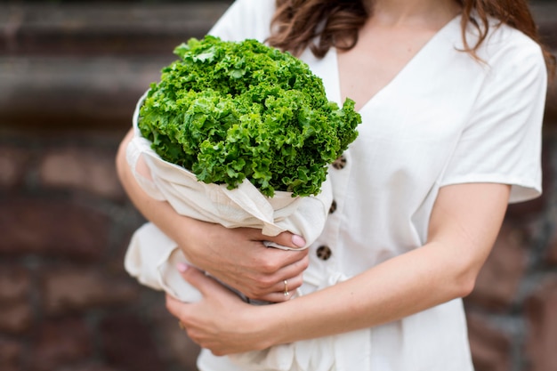 Free photo close-up woman holding groceries bag