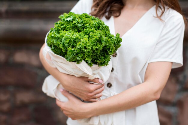 Close-up woman holding groceries bag