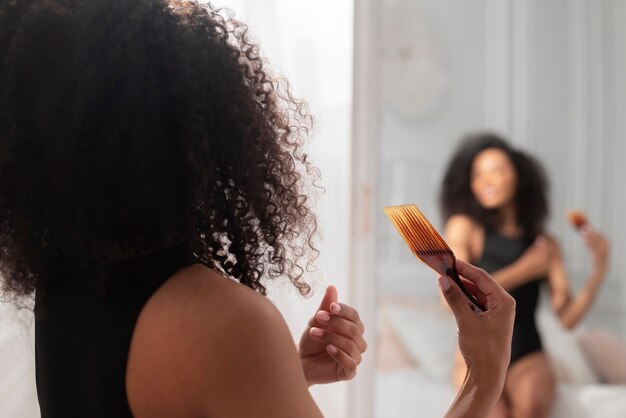 Close up woman holding hair comb