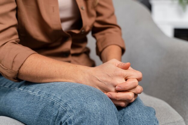 close-up woman holding hands together