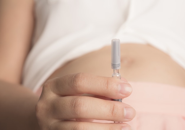 close-up of woman holding an injection