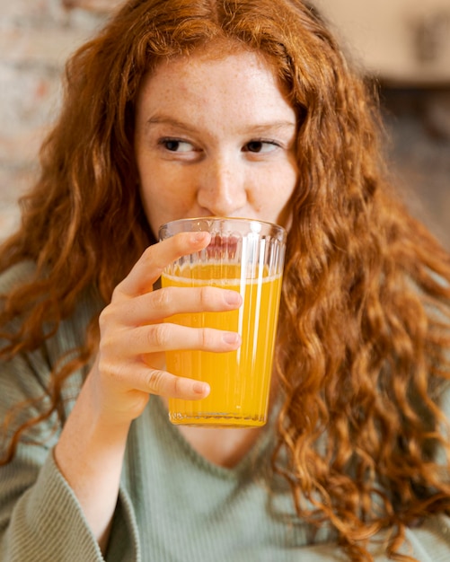 Close up woman holding juice glass