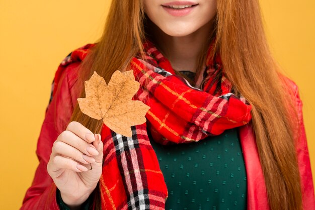 Close-up woman holding leaf
