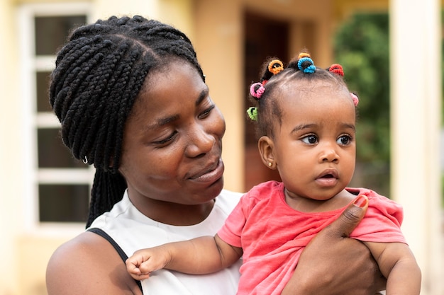 Close up woman holding little kid