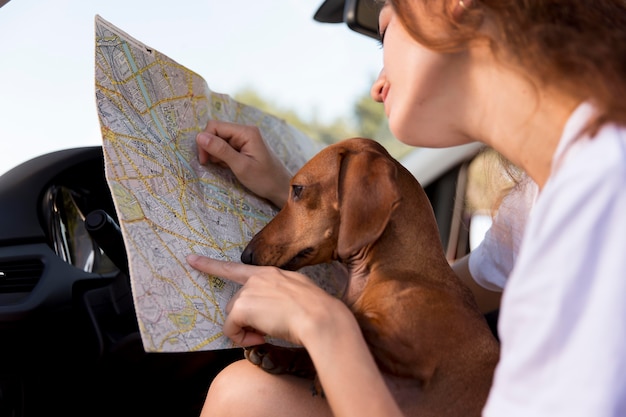 Close up woman holding map in car