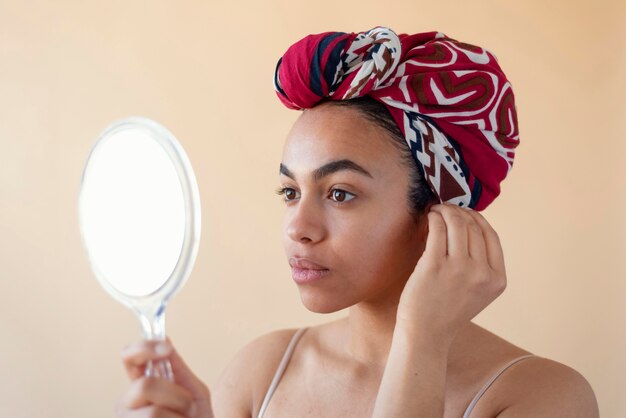 Close up woman holding mirror