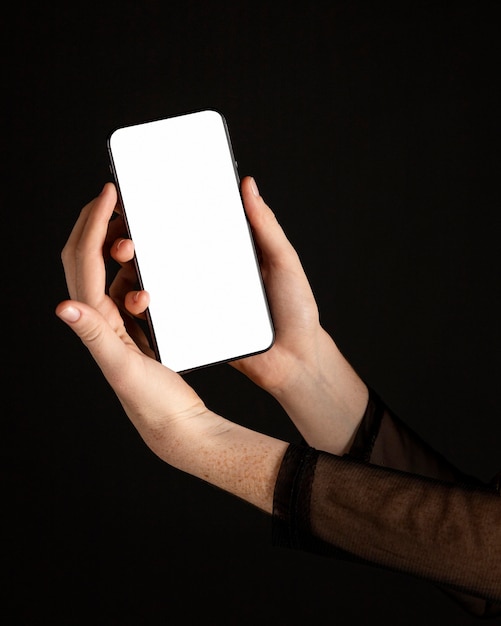 Close-up woman holding a mobile phone