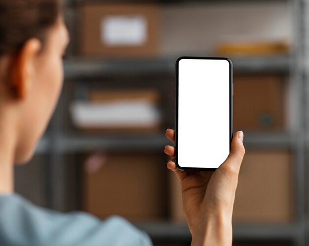 Close up woman holding mobile with blank screen