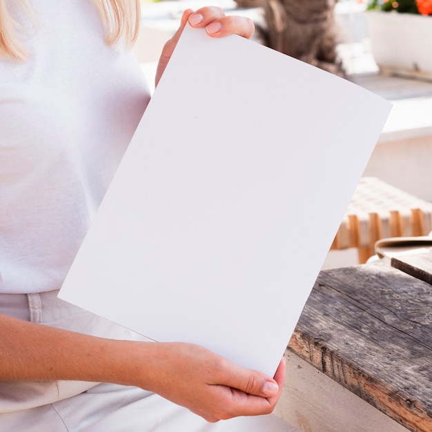 Close-up woman holding a mock-up magazine