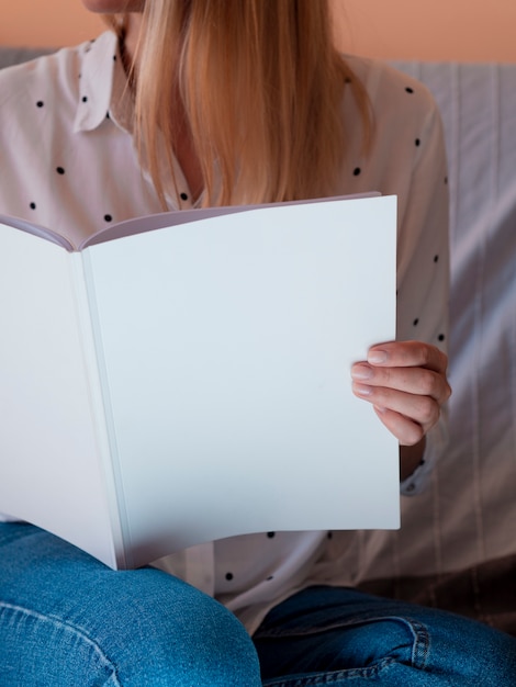 Close-up woman holding a mock-up magazine