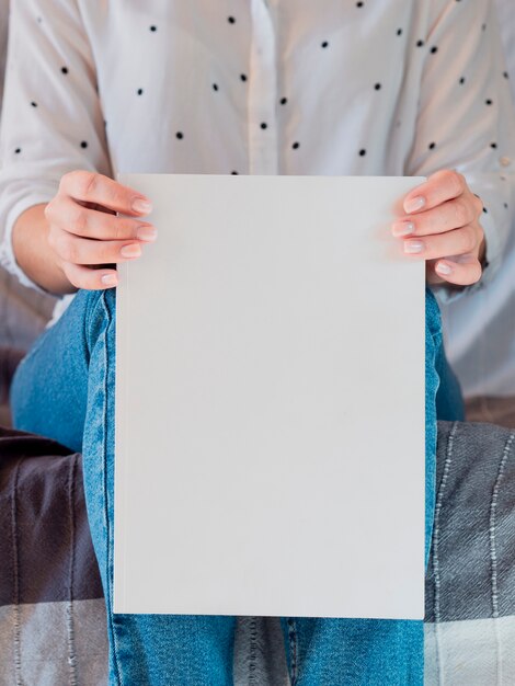 Close-up woman holding a mock-up magazine