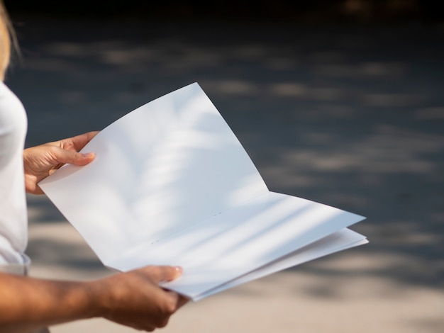 Free photo close-up woman holding a mock-up magazine