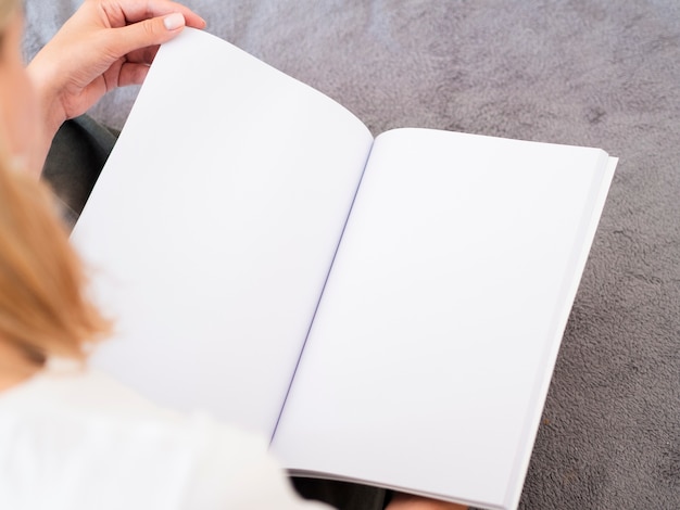 Close-up woman holding a mock-up magazine