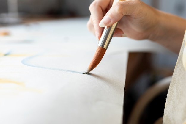 Close-up woman holding painting brush