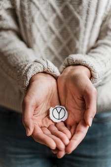 Close up of a woman holding a peace sign