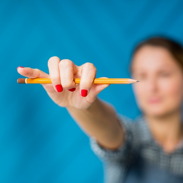 Close-up woman holding a pencil