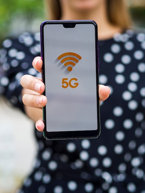 Close-up woman holding phone in front of camera