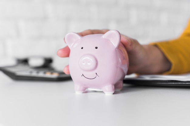 Close-up woman holding piggy bank