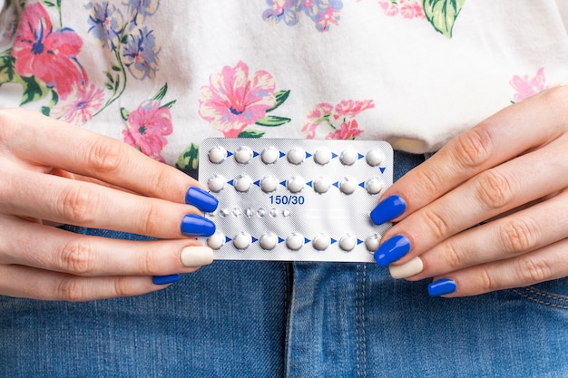 Close-up woman holding pills tablet