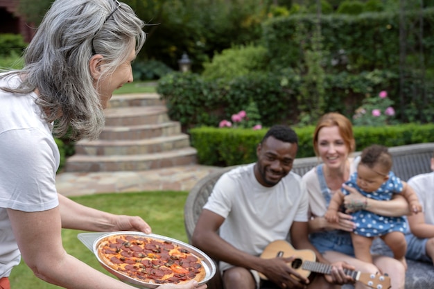 Free photo close up woman holding pizza